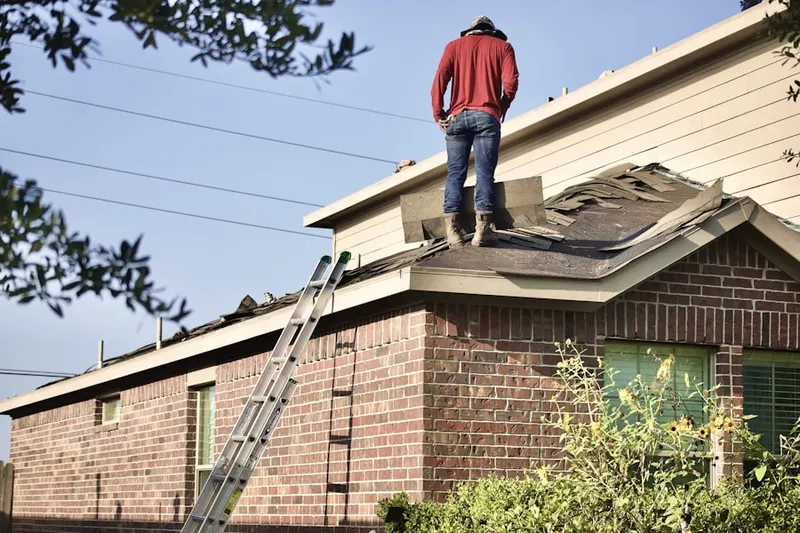 Professional roofer working on a residential roof in Fabyan